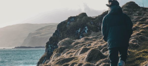 Stormy cliffside with walker