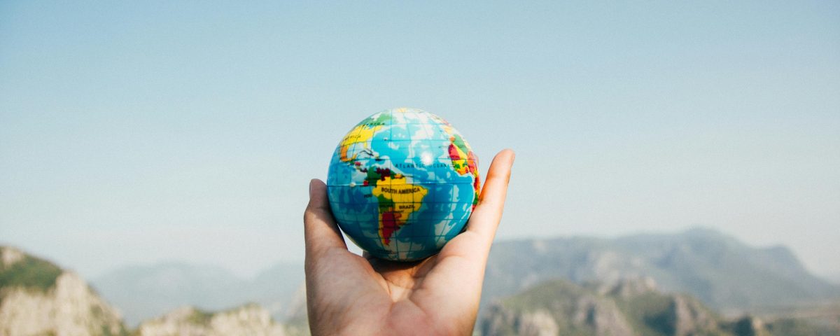 globe in hand, blurred background