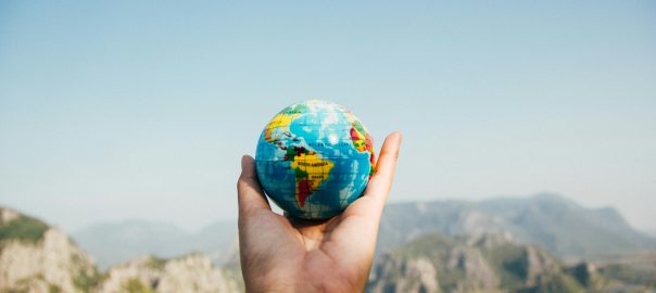 globe in hand, blurred background